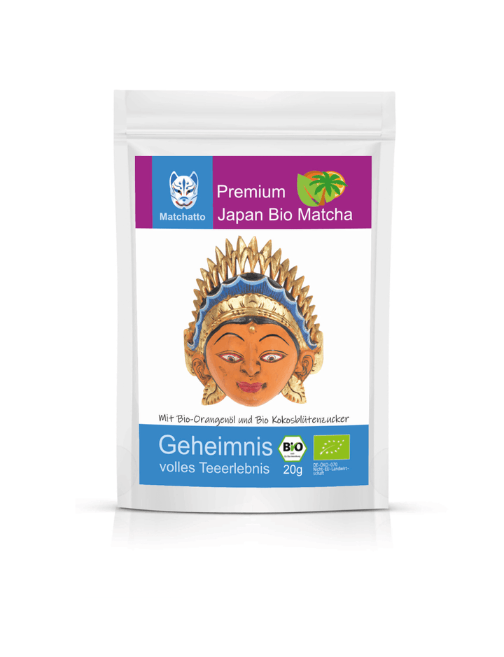 Matchatto Bio Matcha Tee mit Orangenöl und Kokosblütenzucker im 20g-Beutel, mit goldener Sonnengesichtsmaske und Bio-Siegel, fruchtig-mildes Teeerlebnis aus Japan.